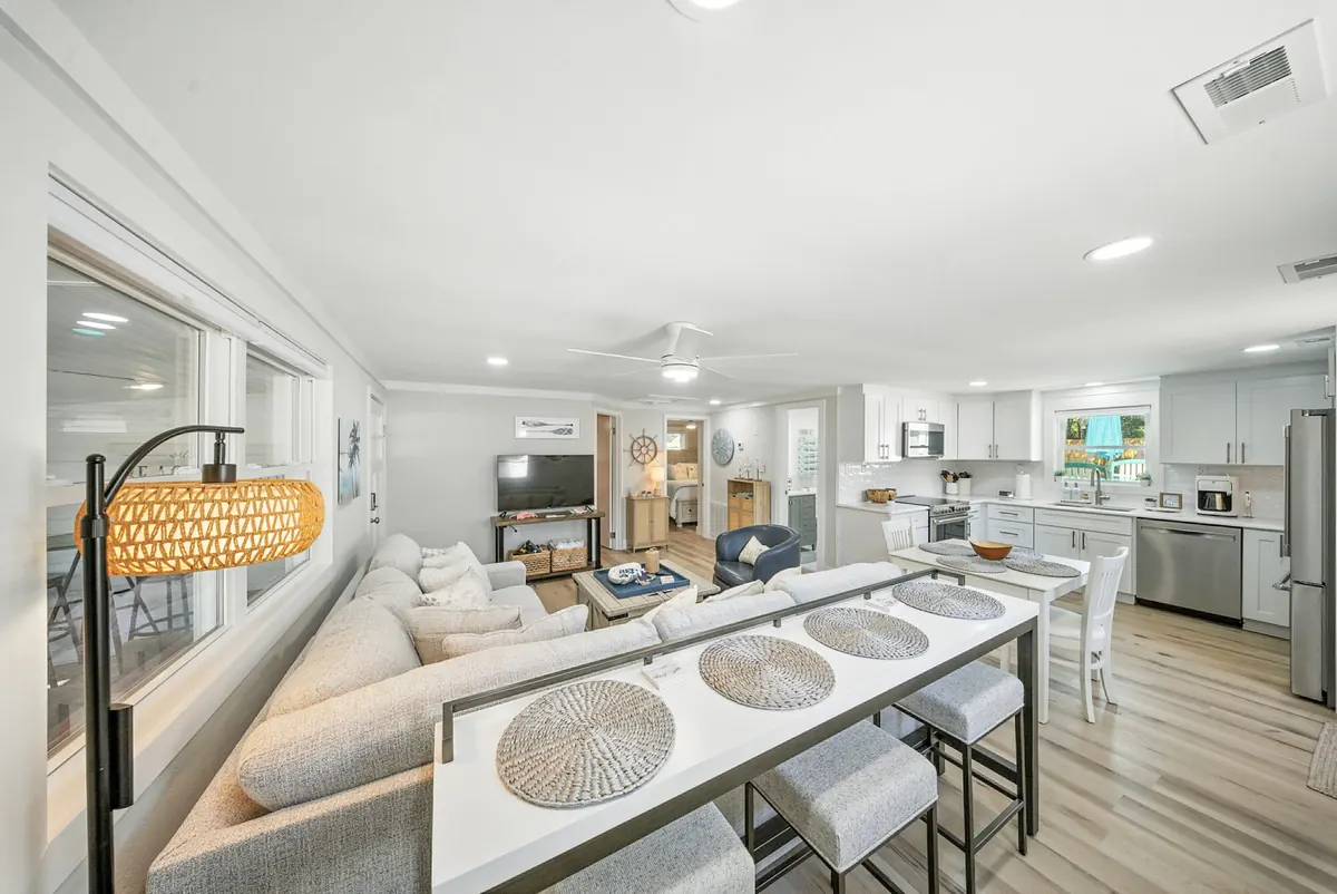 Bright open living room and kitchen with a breakfast bar in a Lake Norman home, photographed by Luma Real Estate Media