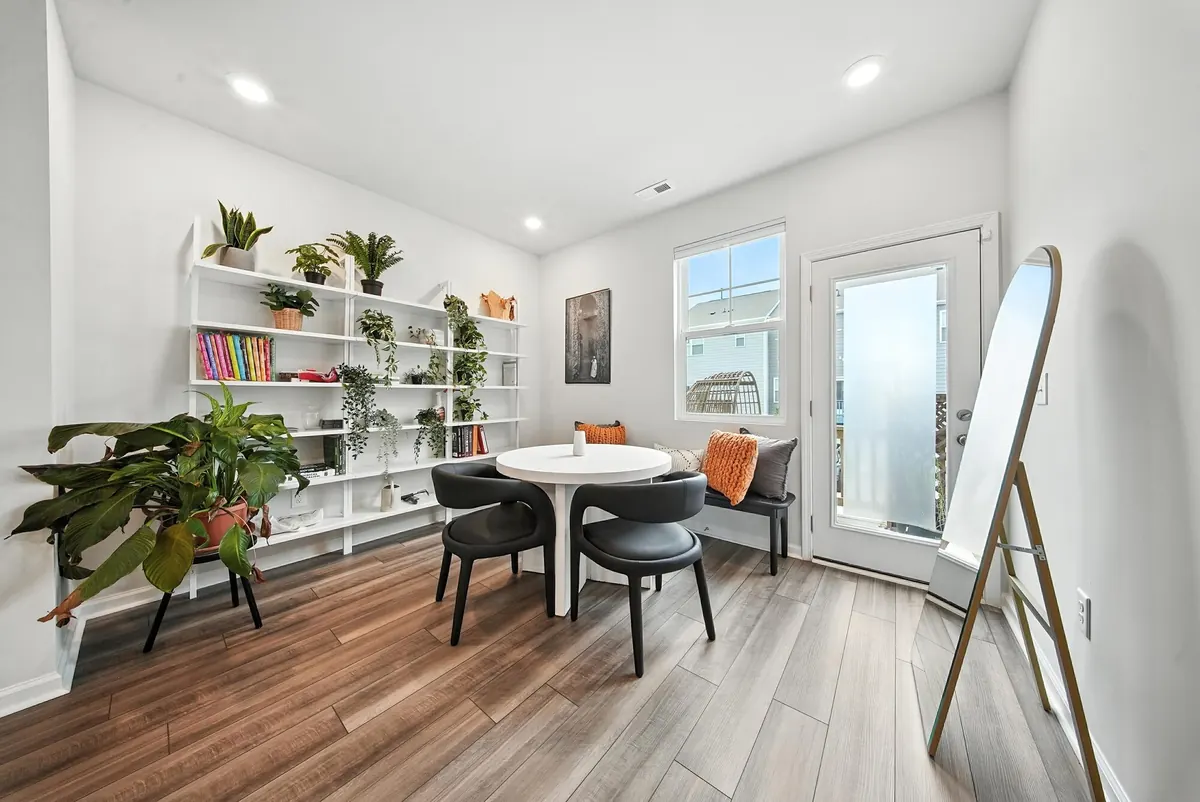Sunny dining nook with a round table, plants and open shelving in a Charlotte listing, photographed by Luma Real Estate Media
